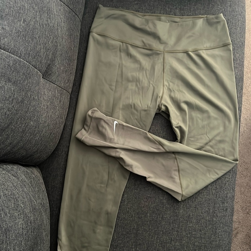 Nike Dri-Fit leggings, white swoosh at bottom/left side, size L, olive green